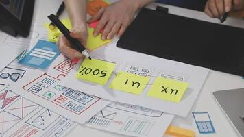 A person is working on a laptop with a sticky note video