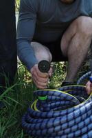 Male hand holding a watering hose photo