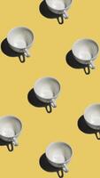 Pattern with many empty tea cups animated on yellow background. Mugs move in different directions. vertical footage video