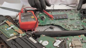 Measuring Motherboard Components with Multimeter, Technician using a multimeter to test motherboard circuits. video
