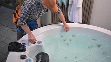 A man is fixing a hot tub in the backyard video