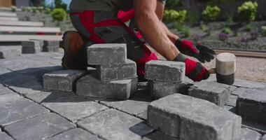 A man is working on a brick patio video