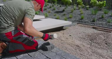 A man is working on a brick path video