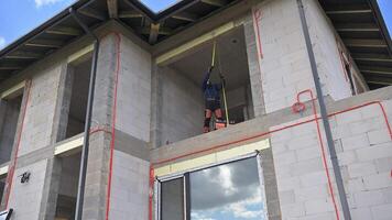 A man on a ladder on the side of a building video
