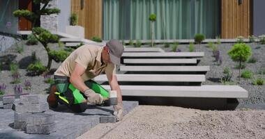 A man is working on a garden with a green tool video