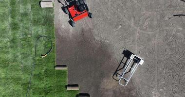A red tractor is parked on a dirt field video