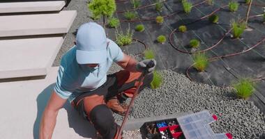 A man is working on a garden with tools video