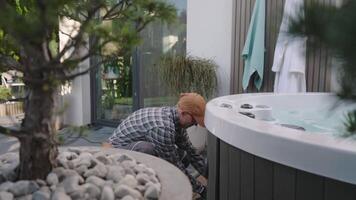 A man is working on a hot tub video