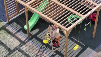 A man is climbing on a wooden structure video