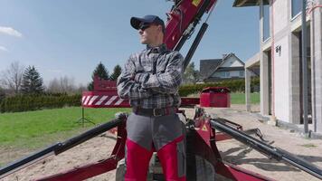 A man standing on a construction site with a crane video