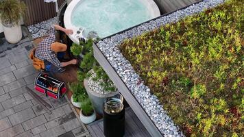 A man is working on a green roof video