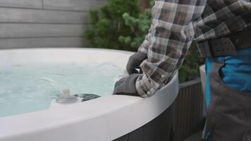 A man is putting water into a hot tub video