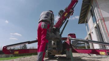A man is standing next to a machine that is on the ground video