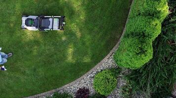 A man is mowing the lawn with a lawn mower video