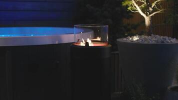 A hot tub with a candle lit on the side video