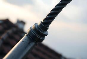 close up of a metal pole with a building in the background photo