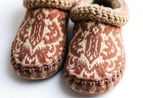 pair of brown and white slippers on a white surface photo