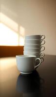 stack of white cups sitting on top of a table photo
