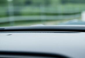 close up of a car dashboard with a blurry background photo