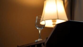 wine glass sitting on a table next to a lamp photo