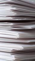 stack of papers sitting on top of a table photo