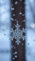 A snowflake is seen through a window with water droplets photo
