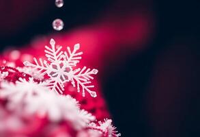 A snowflake is hanging from a red ribbon photo