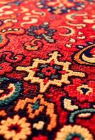 close up of a red rug with a pattern on it photo