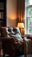 A leather chair and a lamp in front of a window photo