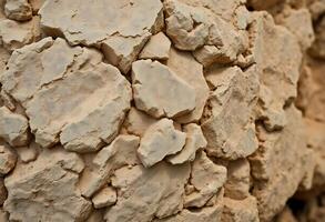 close up of a rock wall with rocks on it photo