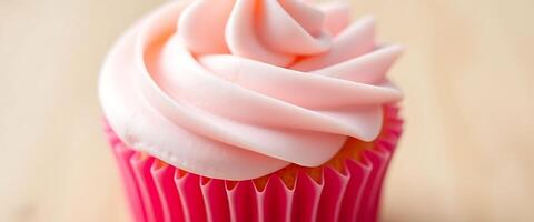 A cupcake with pink frosting on top photo
