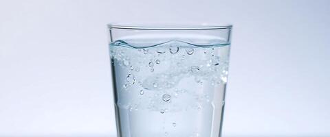 glass filled with water on top of a table photo