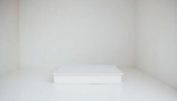 white book sitting on top of a white shelf photo
