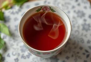 cup of tea with steam rising out of it photo