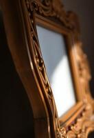 A golden frame with a mirror on it photo