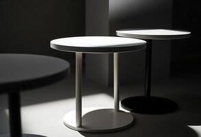 Three white tables with round tops and a black base photo