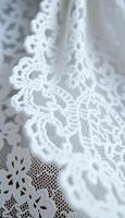 close up of a white lace on a piece of cloth photo