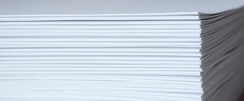 A stack of white paper on a table photo