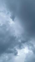 A plane flying through the sky with dark clouds photo