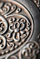 close up of a metal plate with a design on it photo