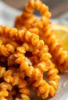 white plate topped with cheetos next to a lemon wedge photo