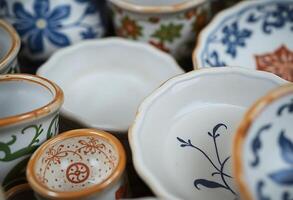 Many different types of ceramic dishes and cups photo