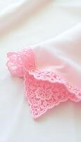 close up of a pink lace on a white sheet photo