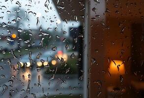 rain drops on a window with a street in the background photo