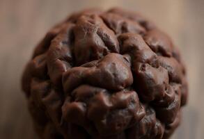close up of a chocolate doughnut on a table photo