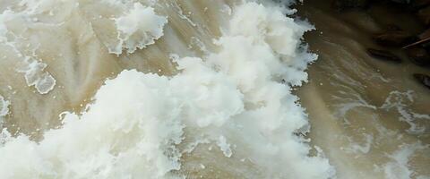 A man is riding a surfboard in a river photo