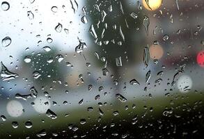 A view of a car driving down the road with rain drops on the window photo