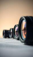 row of camera lens sitting on top of a table photo