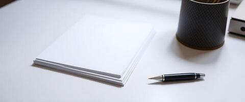 desk with a pen and a notebook on it photo