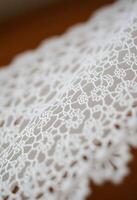 close up of a white lace on a table photo
